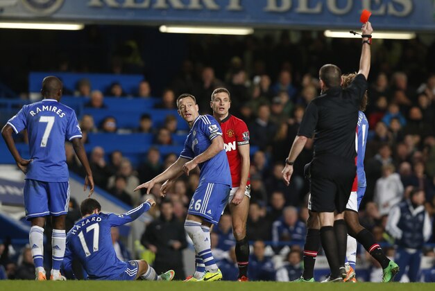 Manchester United's Nemanja Vidic, centre, is shown a red card by referee Phil Dowd during the English Premier League soccer match against Chelsea at Stamford Bridge, London, Sunday, Jan. 19, 2014. (AP Photo/Sang Tan) Manchester United's Nemanja Vidic, centre, is shown a red card by referee Phil Dowd during the English Premier League soccer match against Chelsea at Stamford Bridge, London, Sunday, Jan. 19, 2014. (AP Photo/Sang Tan)