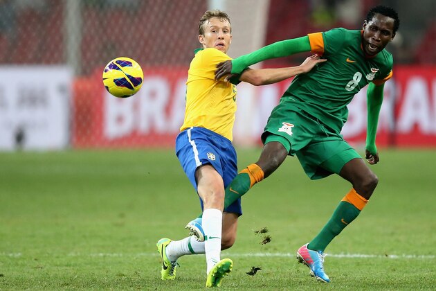 BEIJING, CHINA - OCTOBER 15: Leiva Lucas of Brazil (Left) competes the ball with Mtonga Ondwani of Zambia (Right) during the international friendly match between Brazil and Zambia at Beijing National Stadium on October 15, 2013 in Beijing, China.  (Photo by Feng Li/Getty Images)