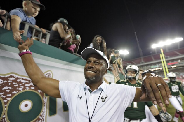 South Florida head coach Willie Taggart celebrates with fans after the team defeated Cincinnati 26-20 during an NCAA college football game Saturday, Oct. 5, 2013, in  Tampa, Fla. (AP Photo/Chris O'Meara)