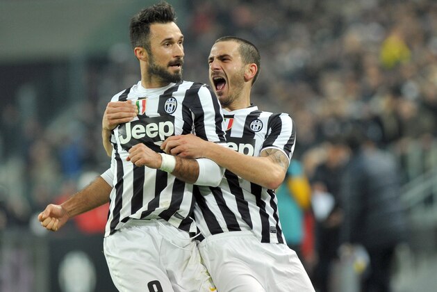 Juventus forward Mirko Vucinic, of Montenegro, left, celebrate with his teammate Leonardo Bonucci after he scored during a Serie A soccer match between Juventus and AS Roma, at the Juventus stadium, in Turin, Italy, Sunday, Jan. 5, 2014. (AP Photo/Massimo Pinca)