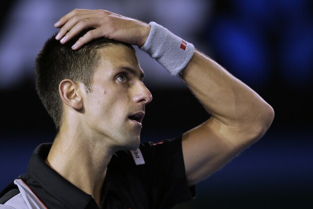 Novak Djokovic of Serbia reacts to a lost point against Stanislas Wawrinka of Switzerland during their quarterfinal at the Australian Open tennis championship in Melbourne, Australia, Tuesday, Jan. 21, 2014.(AP Photo/Rick Rycroft)