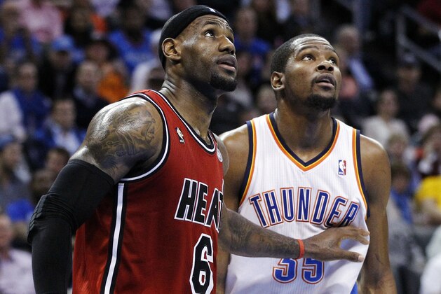 Miami Heat forward LeBron James (6) and Oklahoma City Thunder forward Kevin Durant (35) watch a foul shot during the third quarter of an NBA basketball game in Oklahoma City, Thursday, Feb. 14, 2013. Miami won 110-100. (AP Photo/Sue Ogrocki)