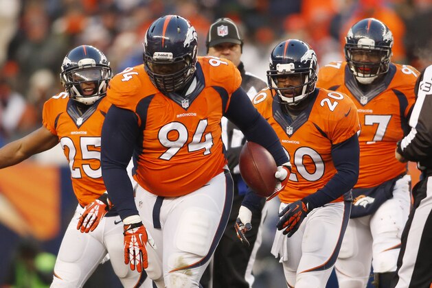 Dec 8, 2013; Denver, CO, USA; Denver Broncos defensive tackle Terrance Knighton (94) after catching an interception during the second half against the Tennessee Titans at Sports Authority Field at Mile High. The Broncos won 51-28.  Mandatory Credit: Chris Humphreys-USA TODAY Sports