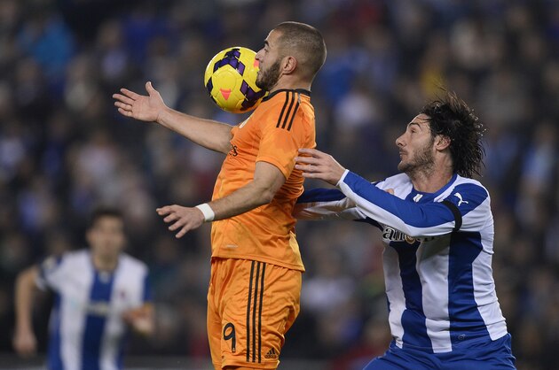 Real Madrid's Karim Benzema, left, duels for the ball against Espanyol's Diego Colotto during a Spanish La Liga soccer match at Cornella-El Prat stadium in Cornella Llobregat, Spain, Sunday, Jan. 12, 2014. (AP Photo/Manu Fernandez) Real Madrid's Karim Benzema, left, duels for the ball against Espanyol's Diego Colotto during a Spanish La Liga soccer match at Cornella-El Prat stadium in Cornella Llobregat, Spain, Sunday, Jan. 12, 2014. (AP Photo/Manu Fernandez)