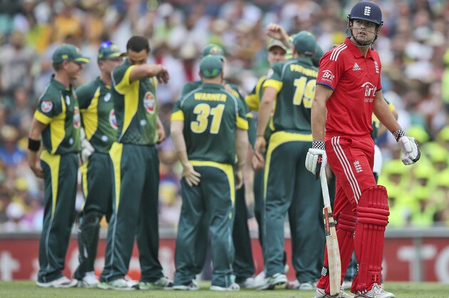 England's captain Alastair Cook, right, looks back after his wicket fell during their one-day international cricket match against Australia at the Sydney Cricket Ground in Sydney, Australia, Sunday, Jan. 19, 2014. (AP Photo/Rob Griffith)