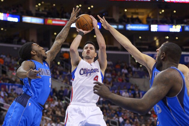 Los Angeles Clippers guard J.J. Redick, second from left, puts up a shot as Dallas Mavericks forward Jae Crowder, left, forward Dirk Nowitzki, second from right, of Germany, and center DeJuan Blair defend during the first half of an NBA basketball game, Wednesday, Jan. 15, 2014, in Los Angeles. (AP Photo/Mark J. Terrill)