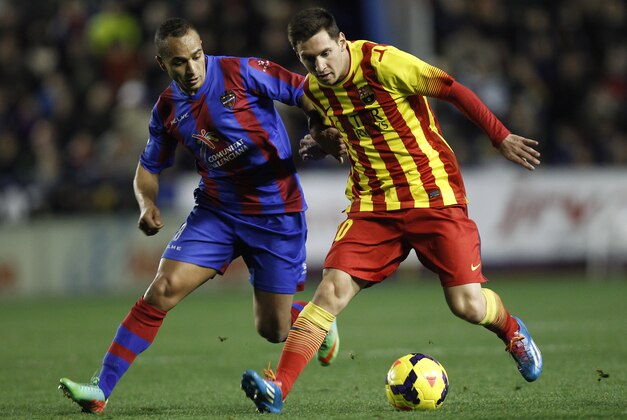Barcelona's Lionel Messi from Argentina duels for the ball with Levante's El Zhar from France during their La Liga soccer match at the Ciutat de Valencia stadium in Valencia, Spain, Sunday, Jan. 19, 2014. (AP Photo/Alberto Saiz)