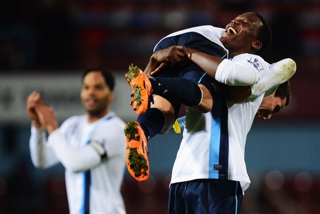 LONDON, ENGLAND - JANUARY 21:  Dedryck Boyata of Manchester City lifts team mate Marcos Mesquita Lopes in celebration after victory in the Capital One Cup Semi-Final, Second Leg match between West Ham United and Manchester City at Boleyn Ground on January 21, 2014 in London, England.  Manchester City win 9-0 on aggregate to reach the final.  (Photo by Jamie McDonald/Getty Images)