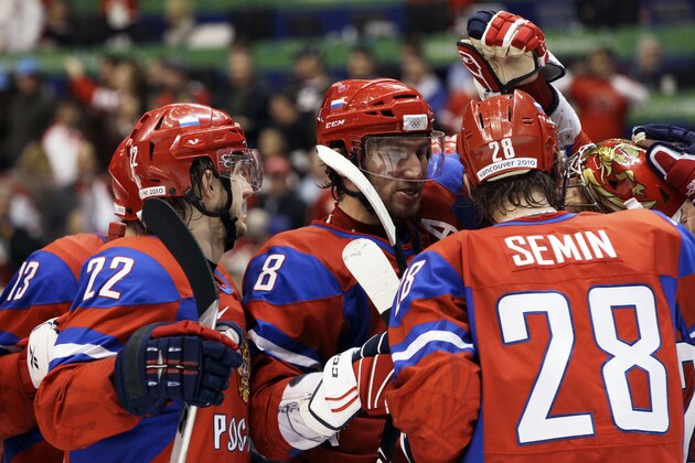 Russia's Konstantin Korneyev (22), Alexander Ovechkin (8) and Alexander Semin (28) congratulate goalie Evgeni Nabokov (20)after a preliminary round men's ice hockey game against the Czech Republic at the Vancouver 2010 Olympics in Vancouver, British Columbia, Sunday, Feb. 21, 2010. Russia won 4-2. (AP Photo/Julie Jacobson)