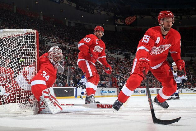 DETROIT, MI - JANUARY 20:  Petr Mrazek #34, Henrik Zetterberg #40 and Niklas Kronwall #55 of the Detroit Red Wings all focus on the play in the corner during an NHL game against the St. Louis Blues on January 20, 2014 at Joe Louis Arena in Detroit, Michigan. (Photo by Dave Reginek/NHLI via Getty Images)