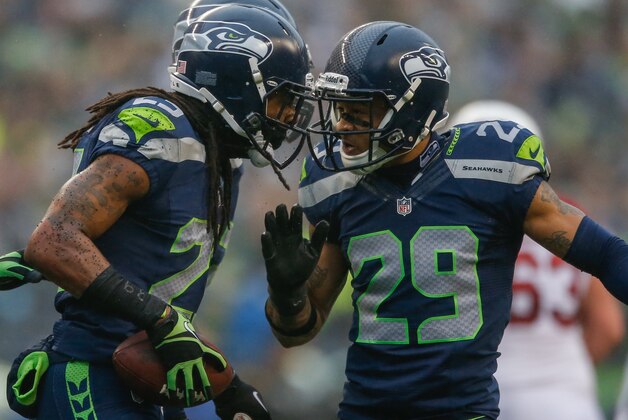 SEATTLE, WA - DECEMBER 22:  Cornerback Richard Sherman #25 of the Seattle Seahawks celebrates with free safety Earl Thomas #29 after making an interception against the Arizona Cardinals at CenturyLink Field on December 22, 2013 in Seattle, Washington.  (Photo by Otto Greule Jr/Getty Images)