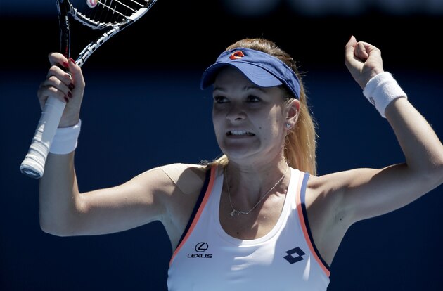 Agnieszka Radwanska of Poland celebrates after defeating Victoria Azarenka of Belarus during their quarterfinal at the Australian Open tennis championship in Melbourne, Australia, Wednesday, Jan. 22, 2014.(AP Photo/Rick Rycroft)