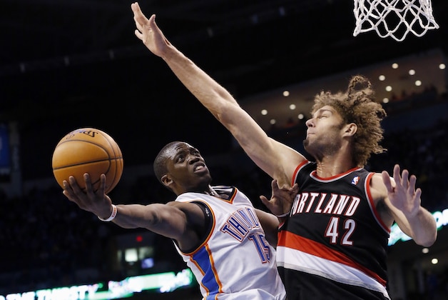 Oklahoma City Thunder guard Reggie Jackson (15) shoots as Portland Trail Blazers center Robin Lopez (42) defends in the third quarter of an NBA basketball game in Oklahoma City, Tuesday, Jan. 21, 2014. Oklahoma City won 105-97. (AP Photo/Sue Ogrocki)