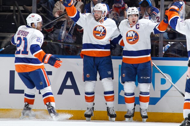 NEW YORK, NY - JANUARY 21:  John Tavares #91, Thomas Vanek #26 and Kyle Okposo #21 of the New York Islanders react after a third-period goal against the New York Rangers at Madison Square Garden on January 21, 2014 in New York City. (Photo by Scott Levy/NHLI via Getty Images)