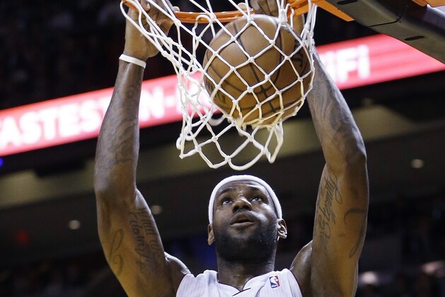 Miami Heat small forward LeBron James (6) scores against the Boston Celtics during the second quarter of an NBA basketball game in Miami, Tuesday, Jan. 21, 2014. (AP PhotoAlan Diaz)