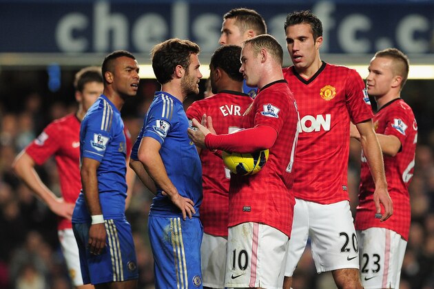 LONDON, ENGLAND - OCTOBER 28: Juan Mata of Chelsea talks to Wayne Rooney of Manchester United as referee Mark Clattenburg looks on during the Barclays Premier League match between Chelsea and Manchester United at Stamford Bridge on October 28, 2012 in London, England.  (Photo by Shaun Botterill/Getty Images)