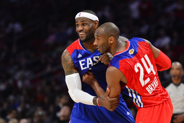 Feb 17, 2013; Houston, TX, USA; Western Conference guard Kobe Bryant (24) of the Los Angeles Lakers grabs onto Eastern Conference forward LeBron James (6) of the Miami Heat in the fourth quarter of the 2013 NBA all star game at the Toyota Center. West won 143-138. Mandatory Credit: Bob Donnan-USA TODAY Sports