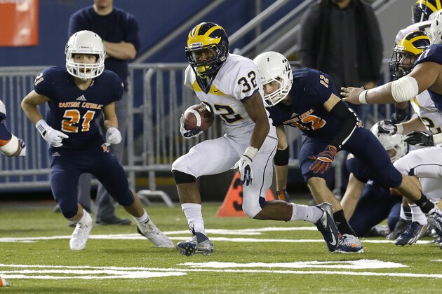 Bellevue running back Budda Baker (32) avoids a tackle from Eastside Catholic's Jonathan Webster, right, in the second half of the Class 3A high school football championship, Friday, Dec. 6, 2013, in Tacoma, Wash. Bellevue beat Eastside Catholic 52-20. (AP Photo/Ted S. Warren)