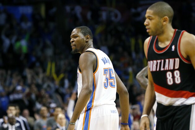 Oklahoma City Thunder forward Kevin Durant (35) talks to the Portland Trail Blazers bench as he and forward Nicolas Batum (88) walk off the court for a timeout in the fourth quarter of an NBA basketball game in Oklahoma City, Tuesday, Jan. 21, 2014. Oklahoma City won 105-97. (AP Photo/Sue Ogrocki)