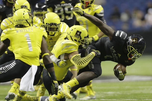 U.S. Army All-American East's Sony Michel (1) is stopped by U.S. Army All-American West's Nyles Morgan, center, during the U.S. Army All-American Bowl football game, Saturday, Jan. 4, 2014, in San Antonio. (AP Photo/Eric Gay)