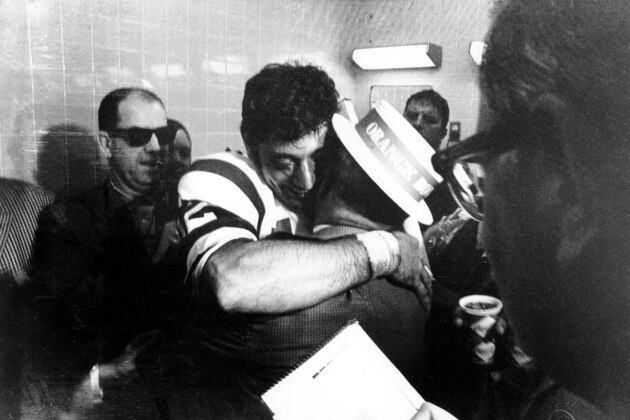 American Football League New York Jets quarterback Joe Namath gives his father, who is wearing an Orange Bowl hat, a big hug in the Jets' crowded dressing room on Jan. 12, 1969. Namath led his underdog team to a 16 to 7 win over the National Football League champion Baltimore Colts in the Super Bowl III game in Miami, Fla. (AP Photo)