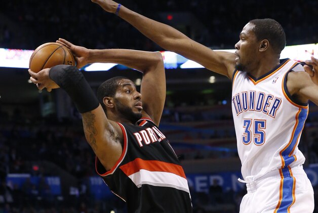 Oklahoma City Thunder forward Kevin Durant (35) defends Portland Trail Blazers forward LaMarcus Aldridge (12) in the first quarter of an NBA basketball game in Oklahoma City, Tuesday, Jan. 21, 2014. (AP Photo/Sue Ogrocki)