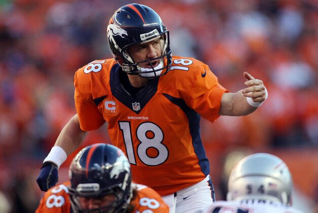 Jan 19, 2014; Denver, CO, USA; Denver Broncos quarterback Peyton Manning (18) signals at the line of scrimmage in the second half against the New England Patriots during the 2013 AFC championship playoff football game at Sports Authority Field at Mile High. Mandatory Credit: Chris Humphreys-USA TODAY Sports