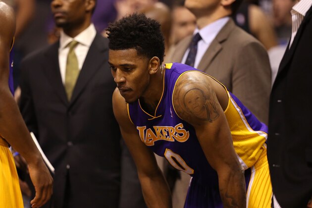 PHOENIX, AZ - JANUARY 15:  Nick Young #0 of the Los Angeles Lakers reacts on the bench after scuffle with the Phoenix Suns during the first half of NBA game at US Airways Center on January 15, 2014 in Phoenix, Arizona.  NOTE TO USER: User expressly acknowledges and agrees that, by downloading and or using this photograph, User is consenting to the terms and conditions of the Getty Images License Agreement.  (Photo by Christian Petersen/Getty Images)