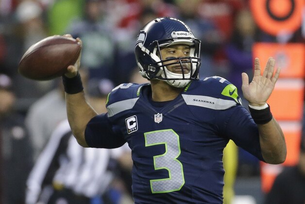 Seattle Seahawks' Russell Wilson throws during the first half of the NFL football NFC Championship game against the San Francisco 49ers, Sunday, Jan. 19, 2014, in Seattle. (AP Photo/Ted S. Warren)