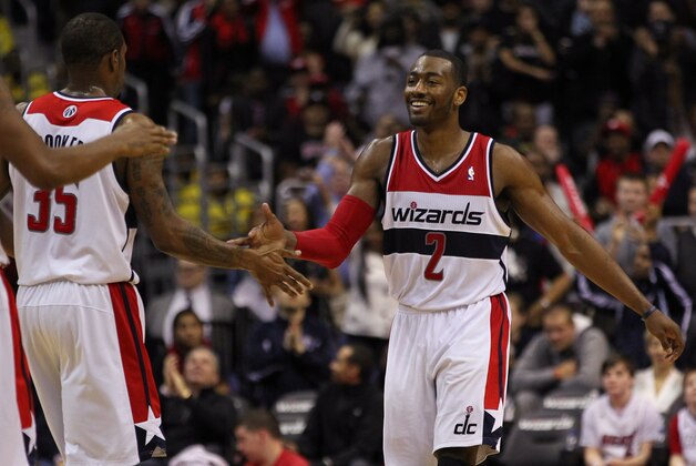 Jan 15, 2014; Washington, DC, USA; Washington Wizards point guard John Wall (2) celebrates with Wizards power forward Trevor Booker (35) against the Miami Heat in the fourth quarter at Verizon Center. The Wizards won 114-97. Mandatory Credit: Geoff Burke-USA TODAY Sports