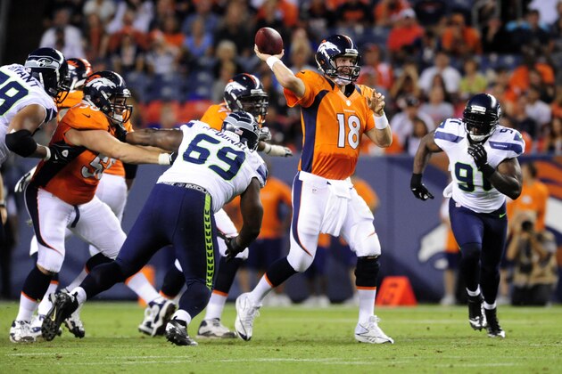 Aug 18, 2012; Denver, CO, USA;  Denver Broncos quarterback Peyton Manning (18) passes in the second quarter against the Seattle Seahawks at Sports Authority Field.  Mandatory Credit: Byron Hetzler-USA TODAY Sports
