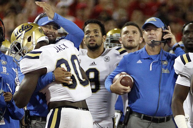 UCLA's Myles Jack (30) is congratulated by linebacker coach Jeff Ulbrich, behind, after recovering the football in the endzone as head coach Jim Mora, right, holds the ball in the second half of an NCAA college football game against Arizona, Saturday, Nov. 9, 2013 in Tucson, Ariz.  UCLA won 31 -26. (AP Photo/Wily Low)