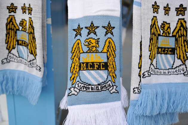 MANCHESTER, ENGLAND - DECEMBER 28:  Detail of Manchester City scarves on a merchandise stall prior to the Barclays Premier League match between Manchester City and Crystal Palace at the Etihad Stadium on December 28, 2013 in Manchester, England.  (Photo by Clint Hughes/Getty Images)