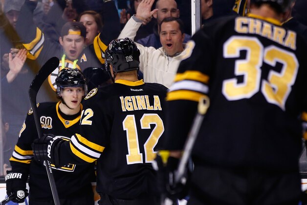 BOSTON, MA - JANUARY 20: Torey Krug #47 of the Boston Bruins is congratulated by teammates after scoring a goal in the first period against the Los Angeles Kings during the game at TD Garden on January 20, 2014 in Boston, Massachusetts.  (Photo by Jared Wickerham/Getty Images)