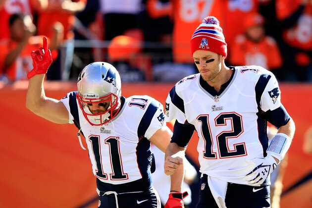 DENVER, CO - JANUARY 19:  Tom Brady #12 and Julian Edelman #11 of the New England Patriots take the field prior to the AFC Championship game against the Denver Broncos at Sports Authority Field at Mile High on January 19, 2014 in Denver, Colorado.  (Photo by Jamie Squire/Getty Images)