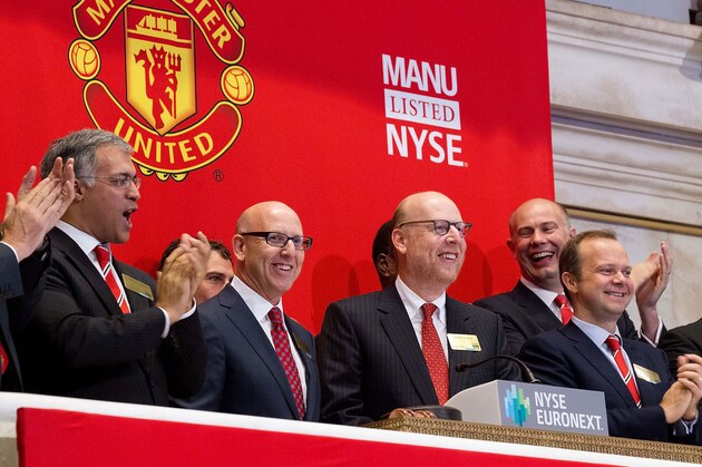 NEW YORK, NY - AUGUST 10:  In this handout photo provided by the NYSE Euronext, Manchester United Executives Joel Glazer (2nd L) and Avram Glazer (C) and Ed Woodward prepare to ring the Opening Bell at the New York Stock Exchange on August 10, 2012 in New York City. Manchester United shares started trading at USD 14.05 at the opening of the New York Stock Exchange. (Photo Dario Cantatore/Getty Images via NYSE Euronext)