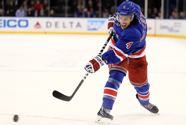 NEW YORK, NY - DECEMBER 12:  Michael Del Zotto #4 of the New York Rangers takes a shot in the second period against the Columbus Blue Jackets at Madison Square Garden on December 12, 2013 in New York City.  (Photo by Elsa/Getty Images)