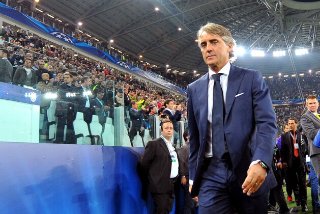 Galatasaray coach Roberto Mancini enters the Juventus Stadium, prior to the Champions League, Group B, soccer match between Juventus and Galatasaray, in Turin, Italy, Wednesday, Oct. 2, 2013. (AP Photo/Massimo Pinca)