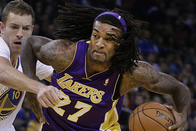 Los Angeles Lakers' Jordan Hill, right, drives the ball against Golden State Warriors' David Lee during the first half of an NBA basketball game Saturday, Dec. 21, 2013, in Oakland, Calif. (AP Photo/Ben Margot)