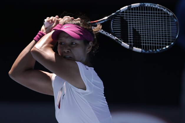 Li Na of China follows through on a shot to  Eugenie Bouchard of Canada during their semifinal at the Australian Open tennis championship in Melbourne, Australia, Thursday, Jan. 23, 2014.(AP Photo/Rick Rycroft)