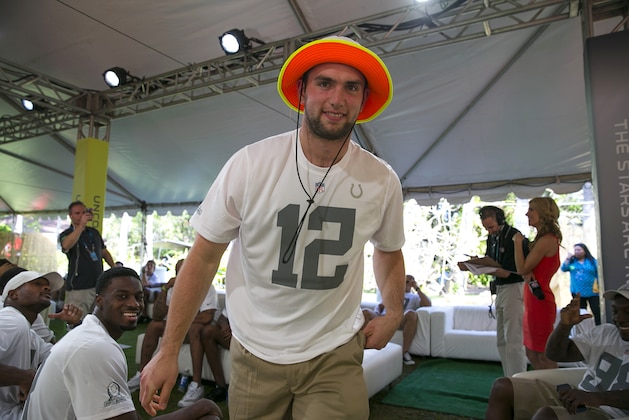 Indianapolis Colts quarterback Andrew Luck walks out to the stage after being chose in the NFL football Pro Bowl draft, Wednesday, Jan. 22, 2014, in Kapolei, Hawaii. (AP Photo/Marco Garcia)