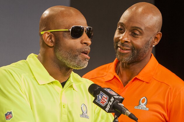 Pro Football Hall of Famer Jerry Rice, right, reacts to comments made by fellow Hall of Famer Deion Sanders during a news conference for the NFL Pro Bowl Draft, Tuesday, Jan. 21, 2014, Kapolei, Hawaii.  (AP Photo/Marco Garcia)