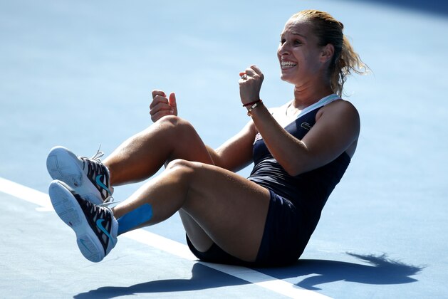 Dominika Cibulkova of Slovakia celebrates after defeating  Agnieszka Radwanska of Poland during their semifinal at the Australian Open tennis championship in Melbourne, Australia, Thursday, Jan. 23, 2014.(AP Photo/Aaron Favila)