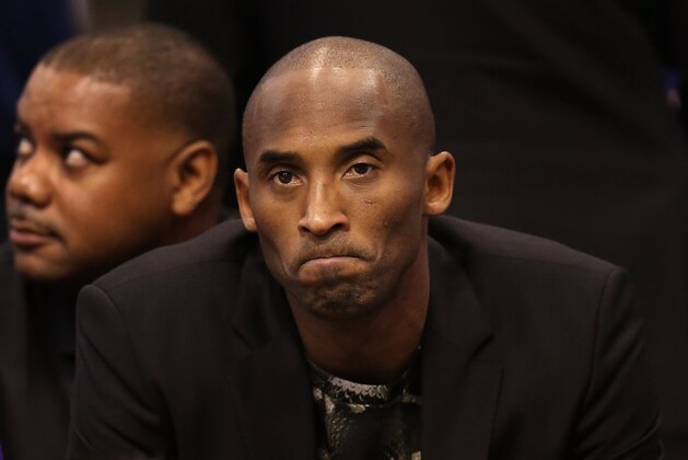 PHOENIX, AZ - JANUARY 15:  Kobe Bryant #24 of the Los Angeles Lakers watches from the bench during the NBA game against the Phoenix Suns at US Airways Center on January 15, 2014 in Phoenix, Arizona.  NOTE TO USER: User expressly acknowledges and agrees that, by downloading and or using this photograph, User is consenting to the terms and conditions of the Getty Images License Agreement.  (Photo by Christian Petersen/Getty Images)