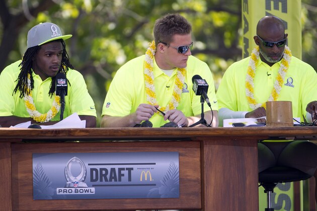 Kansas City Chiefs running back Jamaal Charles, left, Houston Texans defensive end J.J. Watt, center, and Hall of Famer and alumni team captain Deion Sanders, right, check their notes during day two of the 2014 Pro Bowl Draft, Wednesday, Jan. 22, 2014, in Kapolei, Hawaii. (AP Photo/Eugene Tanner)