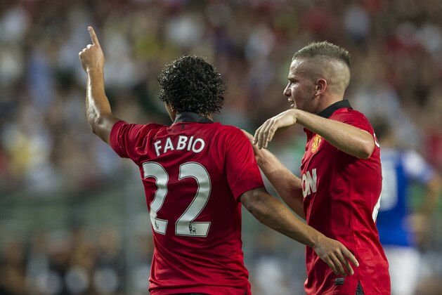 SO KON PO, HONG KONG - JULY 29:  Fabio da Silva (L) of Manchester United celebrates his goal with team mate Tom Cleverley during the international friendly match between Kitchee FC and Manchester United at Hong Kong Stadium on July 29, 2013 in So Kon Po, Hong Kong.  (Photo by Victor Fraile/Getty Images)