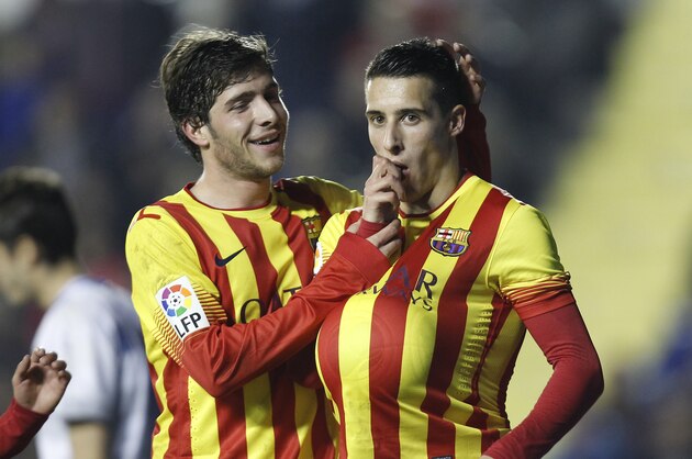 Barcelona's Cristian Tello, right, is congratulated by teammate Sergi Roberto after scoring a goal against  Levante during their la Copa del Rey soccer match at the Ciutat de Valencia stadium in Valencia, Spain, Wednesday, Jan. 22, 2014. (AP Photo/Alberto Saiz)