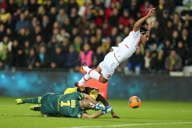 FILE - In this Dec. 24, 2013 file photo, Monaco’s forward Falcao falls as he tries to reach the ball during a challenge with Nantes' defender Isaa Cissokho and goalkeeper Remy Riou during their French League One soccer match in Nantes, France. Falcao was injured this Wednesday, Jan. 22, 2014 during a French Cup game against Chasselay.  (AP Photo/David Vincent, File)