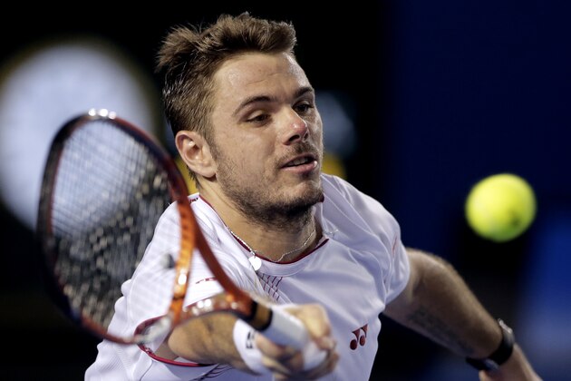 Stanislas Wawrinka of Switzerland makes a forehand return to Tomas Berdych of the Czech Republic during their semifinal at the Australian Open tennis championship in Melbourne, Australia, Thursday, Jan. 23, 2014.(AP Photo/Rick Rycroft)