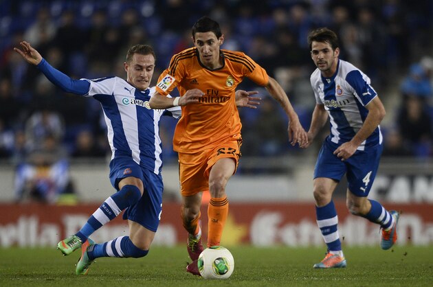 Real Madrid's Angel Di Maria, from Argentina, center, duels for the ball against Espanyol's Abraham Gonzalez, left, and Victor Sanchez during a Copa del Rey soccer match at Cornella-El Prat stadium in Cornella Llobregat , Spain, Tuesday, Jan. 21, 2014. (AP Photo/Manu Fernandez)